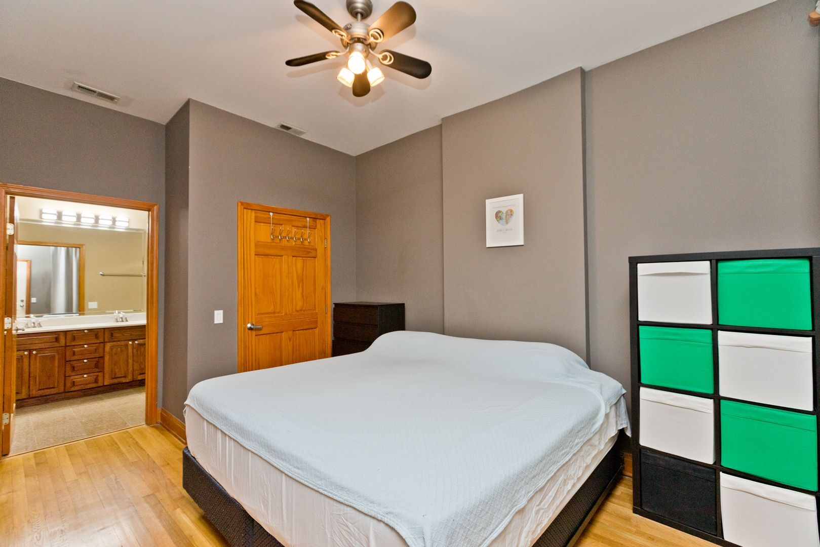 842 West Adams Street, Unit 3 Chicago, IL 60607 - Photo 6 of 12 a bedroom with a large bed and a chandelier