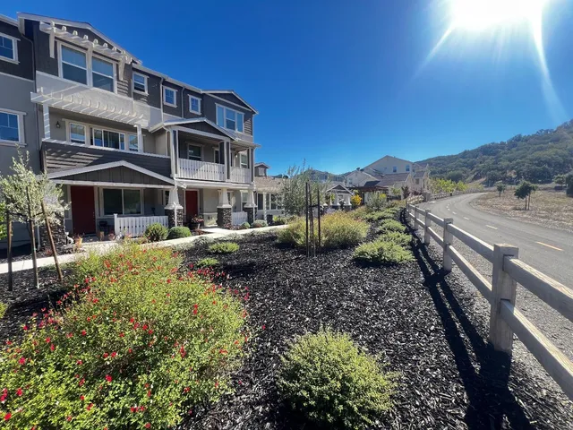 a view of a house with a yard and sitting area