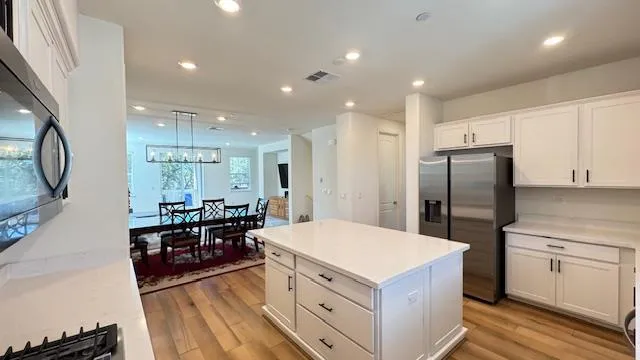 a kitchen with a sink appliances and cabinets