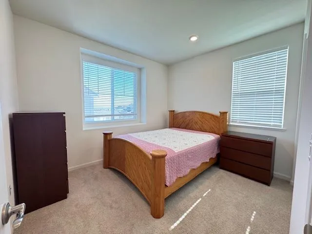 a bedroom with a bed and window