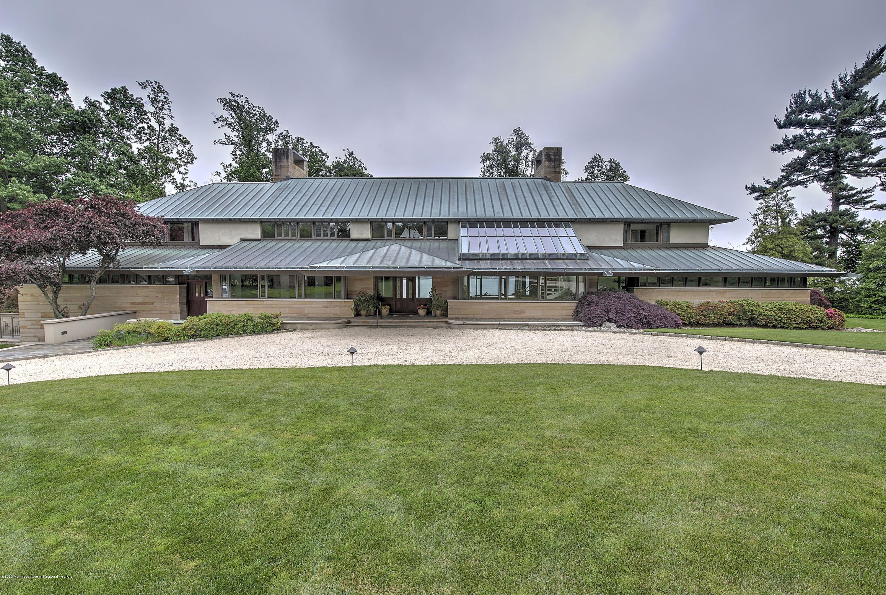 546 Navesink River Road Middletown, NJ 07701 - Photo 1 of 1 a front view of a house with a yard and garage