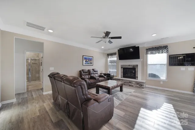 a living room with furniture fireplace and a flat screen tv