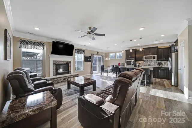a living room with furniture a fireplace and a flat screen tv