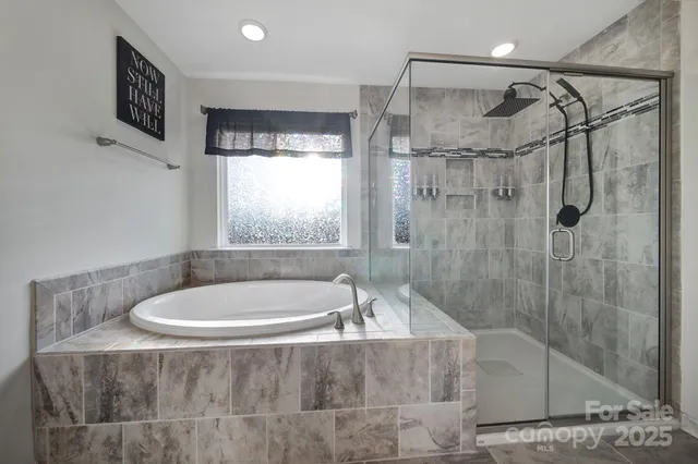 a bath tub sitting in a bathroom next to a window
