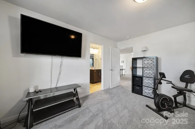 a view of a livingroom with furniture and a flat screen tv
