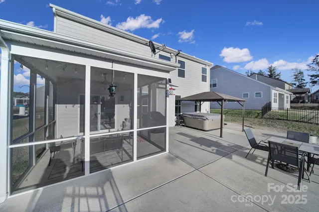 a view of a porch with a table and chairs