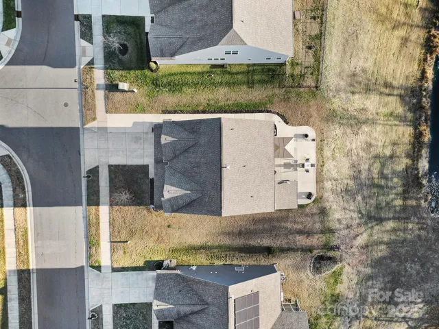 a aerial view of a house with a yard