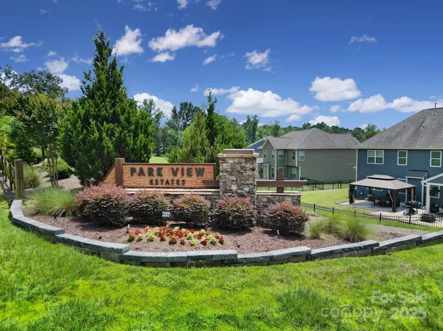 a view of a house with swimming pool and a yard
