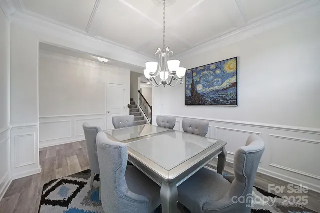 a view of a dining room with furniture and chandelier