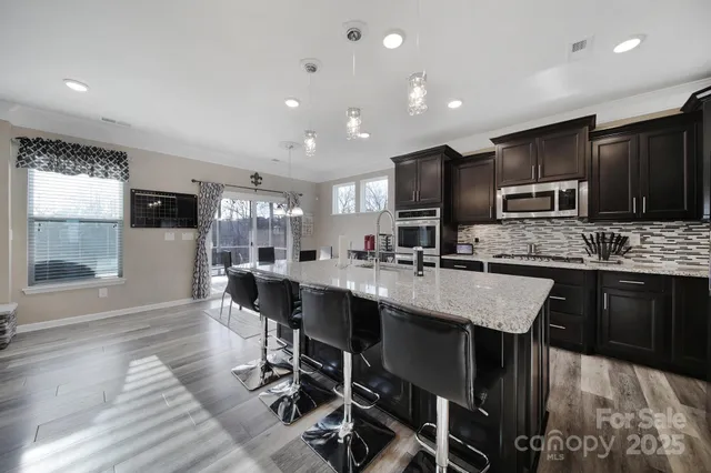 a large kitchen with a table and chairs