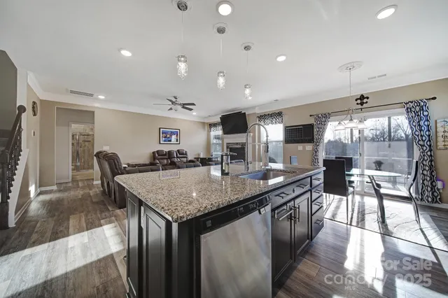 a kitchen with center island and view of living room