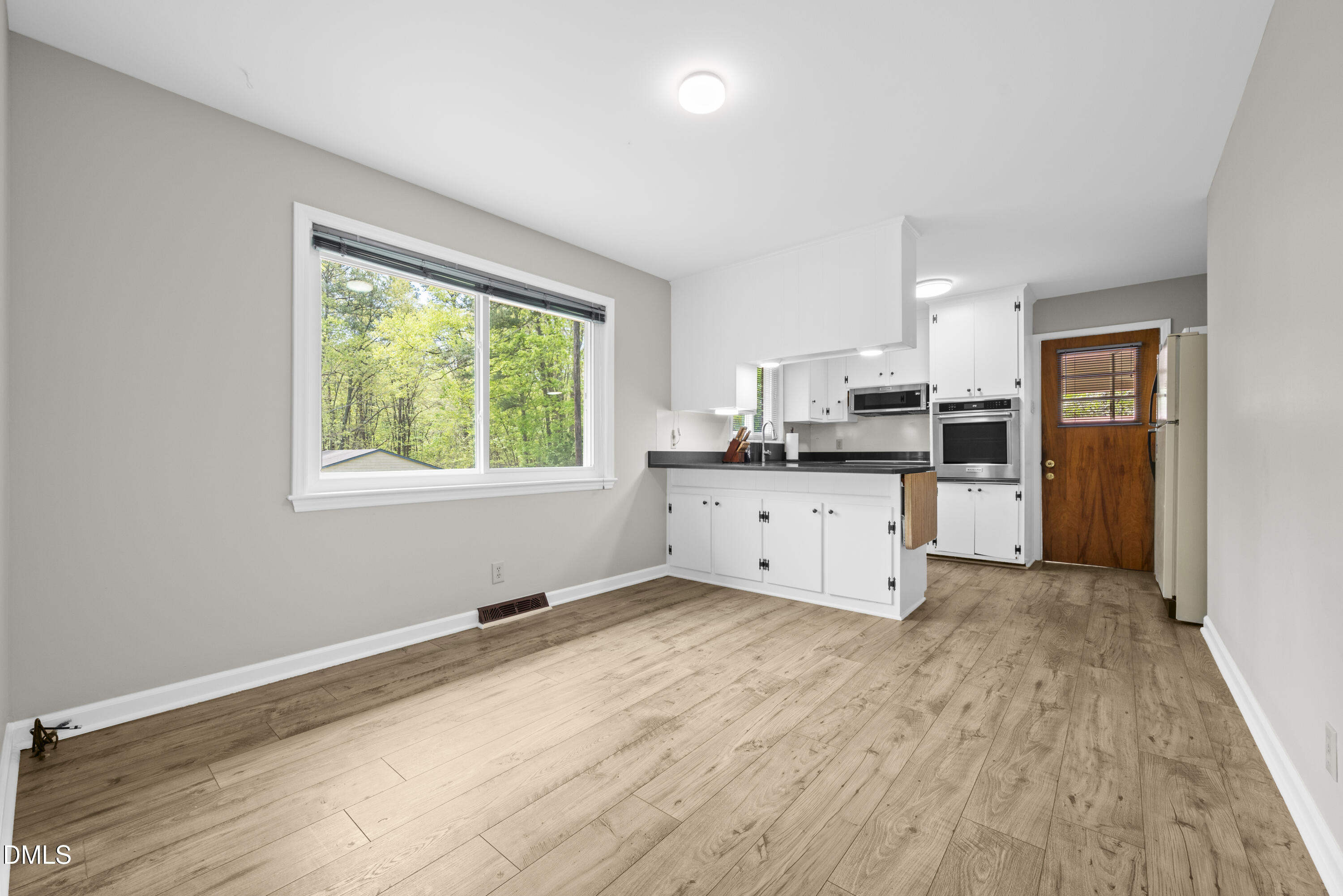518 Goodwin Road Durham, NC 27712 - Photo 11 of 38 a kitchen with stainless steel appliances granite countertop a stove a sink dishwasher and a refrigerator with wooden floor