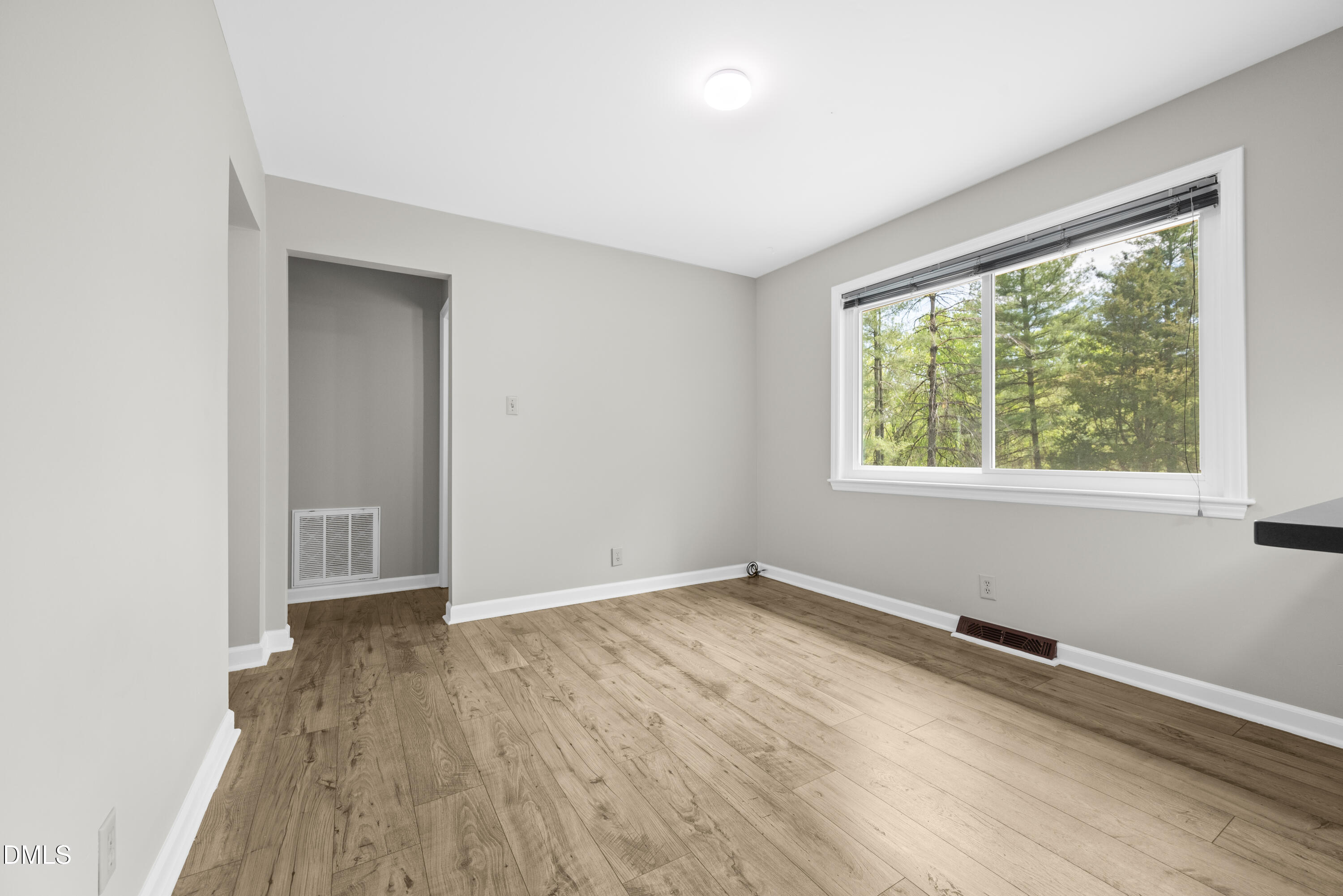518 Goodwin Road Durham, NC 27712 - Photo 12 of 38 an empty room with wooden floor and windows