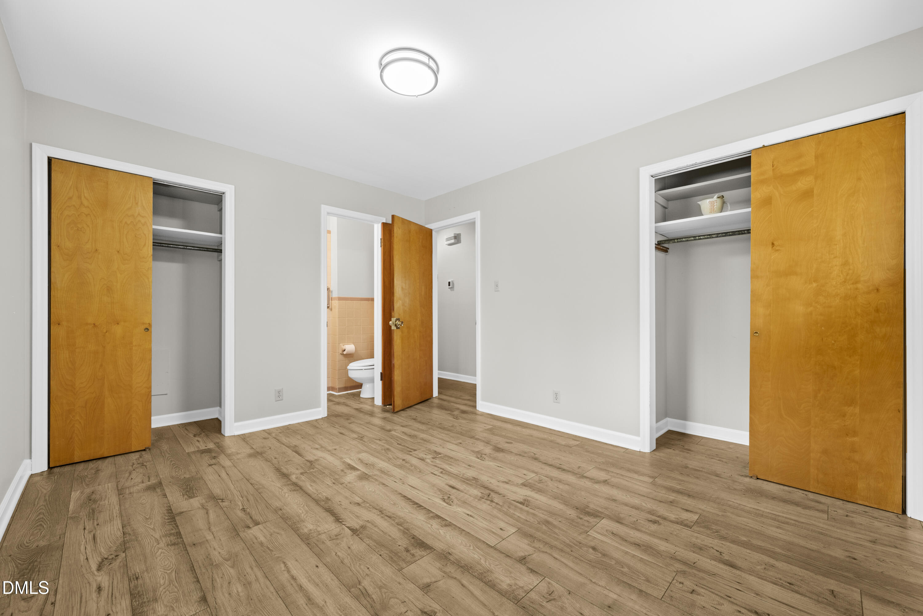 518 Goodwin Road Durham, NC 27712 - Photo 14 of 38 a view of an empty room with wooden floor and a window