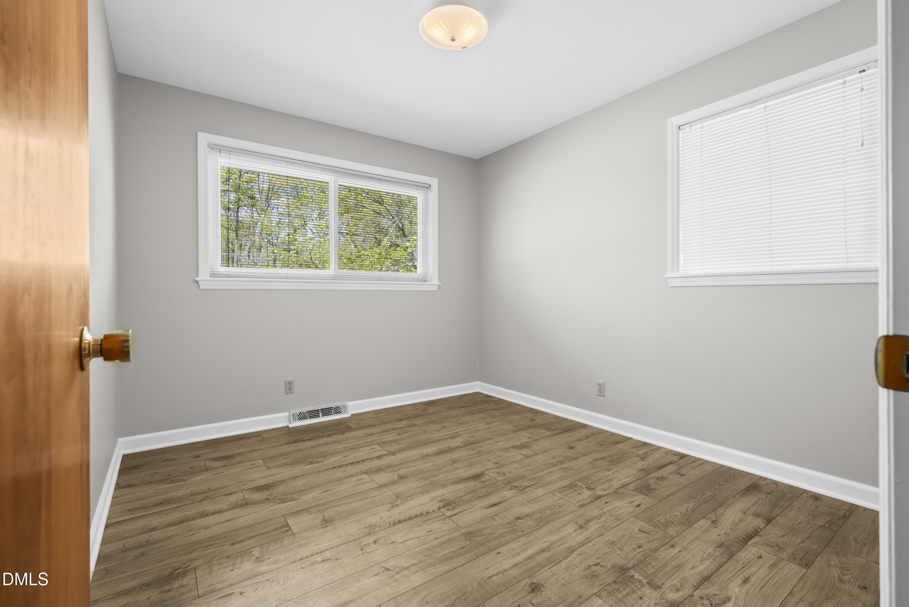 518 Goodwin Road Durham, NC 27712 - Photo 17 of 38 a view of an empty room with wooden floor and a window