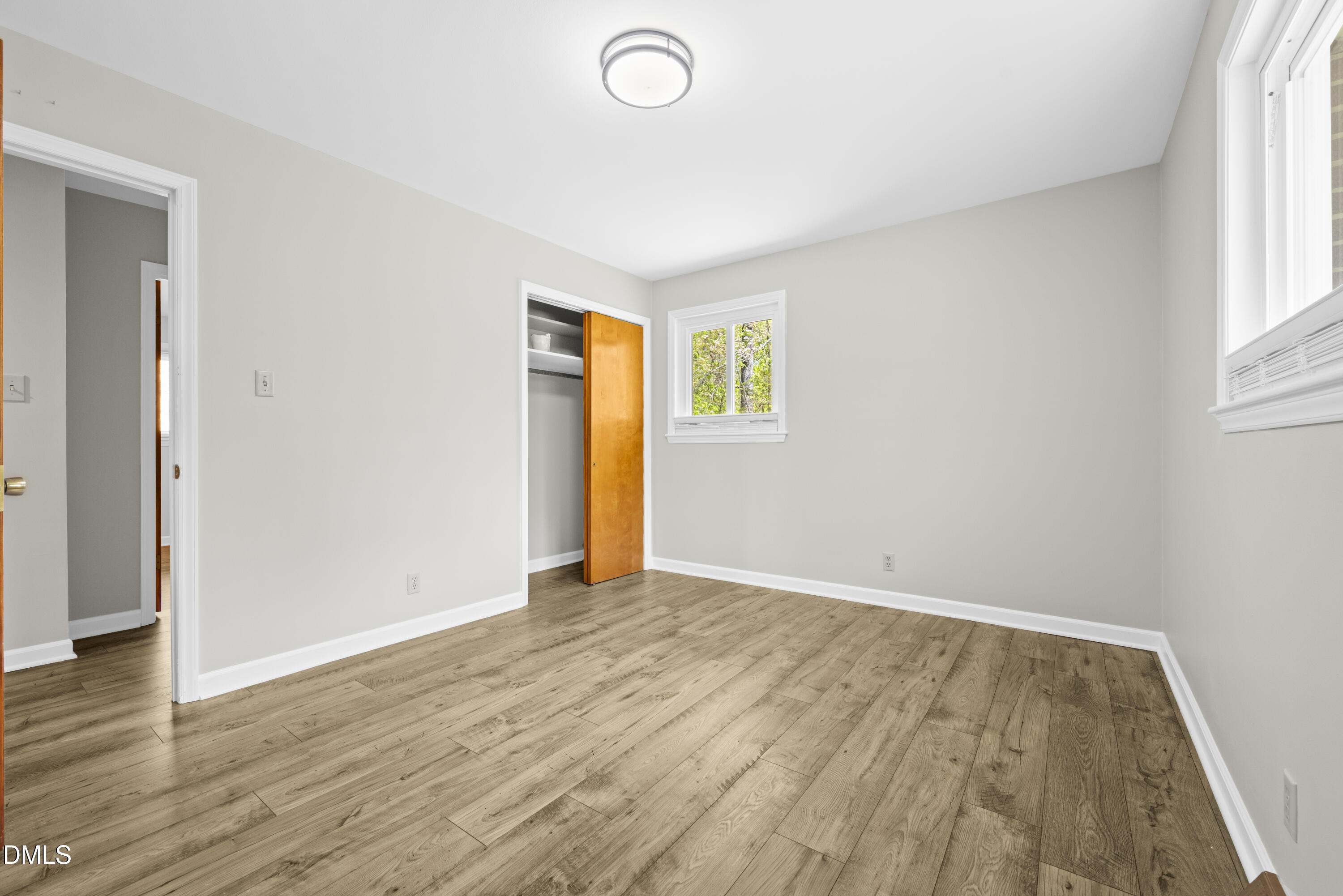 518 Goodwin Road Durham, NC 27712 - Photo 18 of 38 an empty room with wooden floor and windows