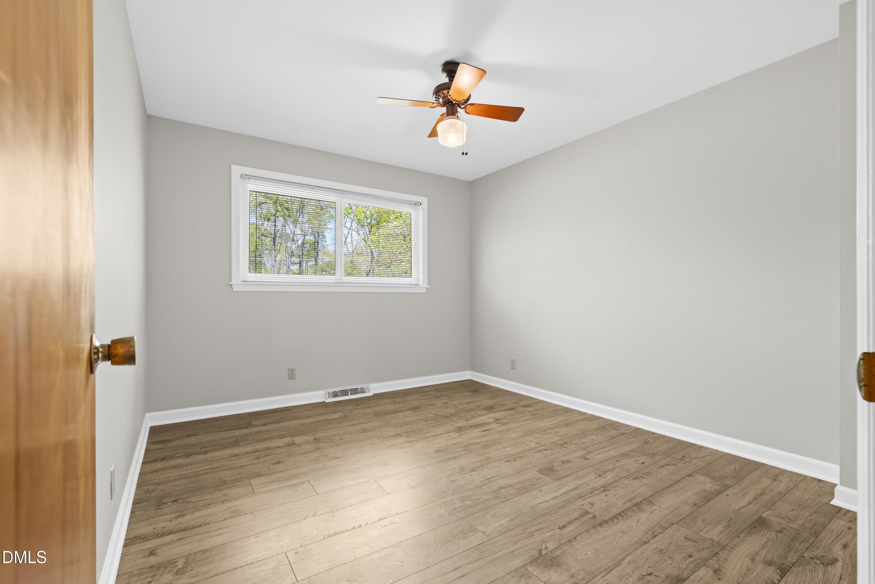 518 Goodwin Road Durham, NC 27712 - Photo 20 of 38 an empty room with a window and wooden floor