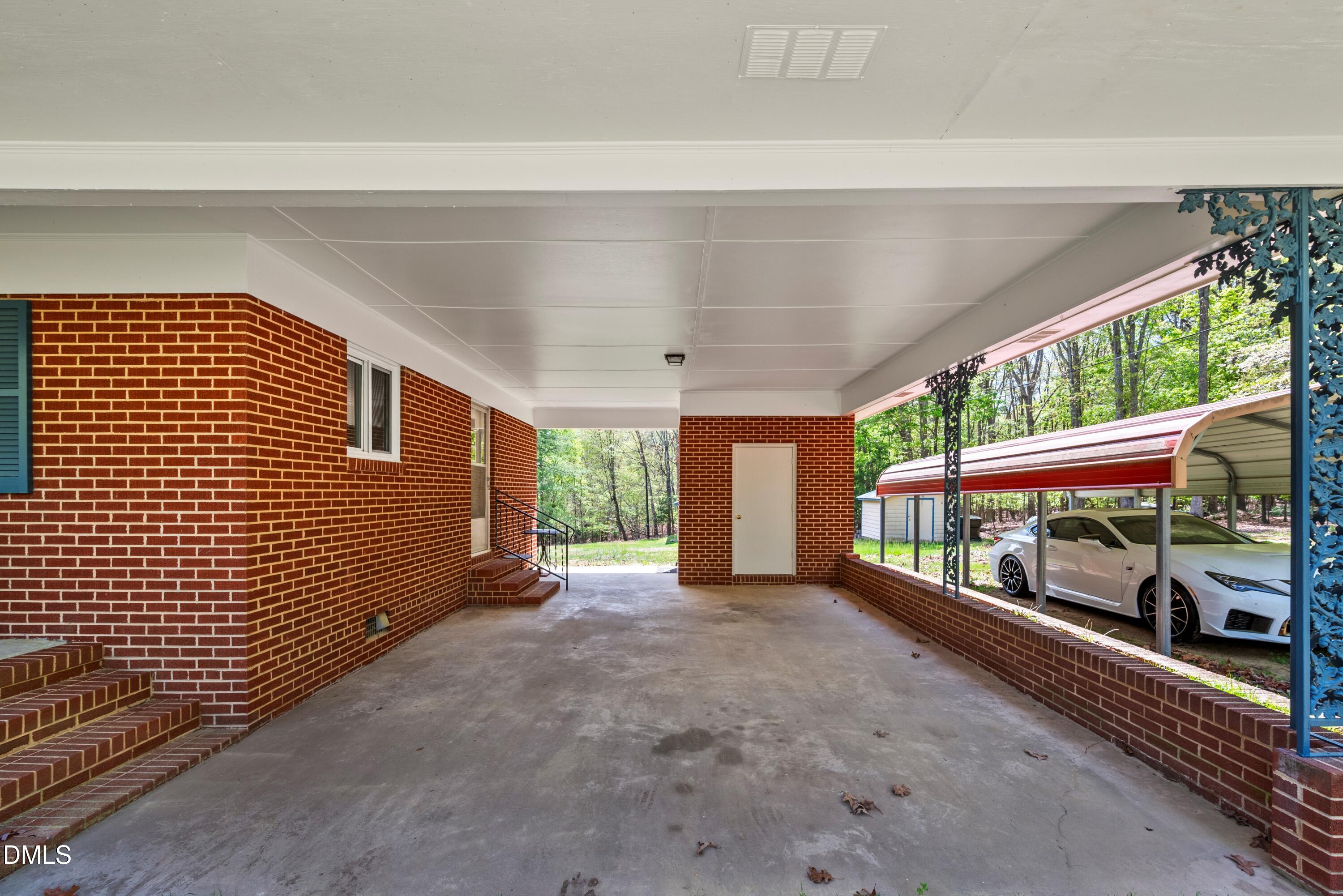518 Goodwin Road Durham, NC 27712 - Photo 23 of 38 a view of a porch with wooden floor and iron stairs