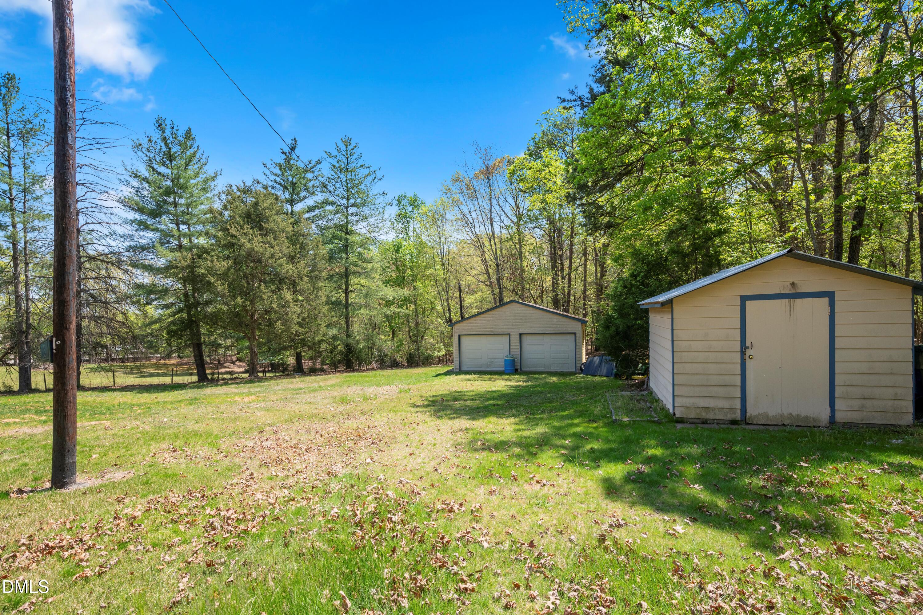 518 Goodwin Road Durham, NC 27712 - Photo 26 of 38 a view of a backyard with large trees and wooden fence