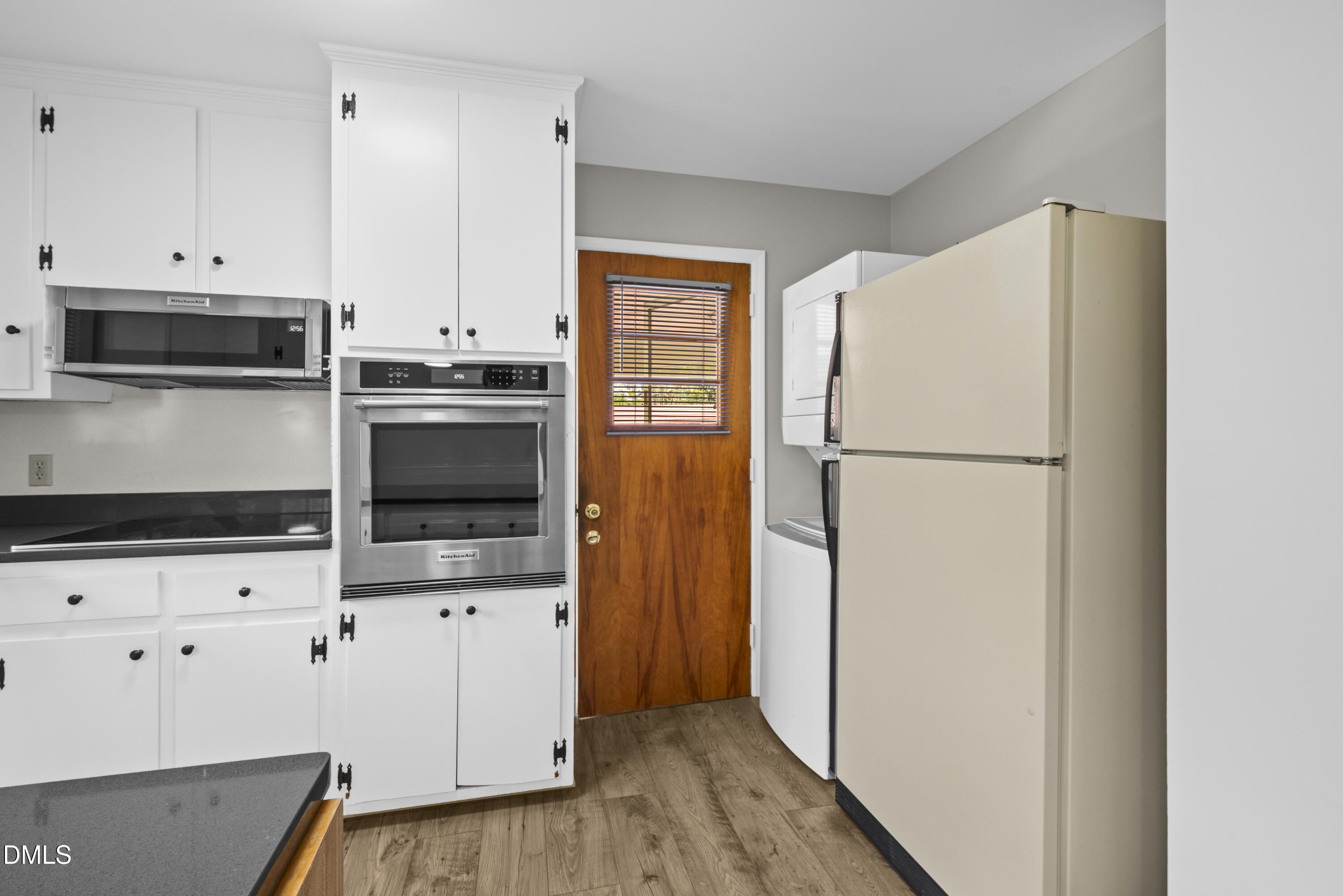518 Goodwin Road Durham, NC 27712 - Photo 6 of 38 a kitchen with granite countertop a refrigerator and a stove top oven