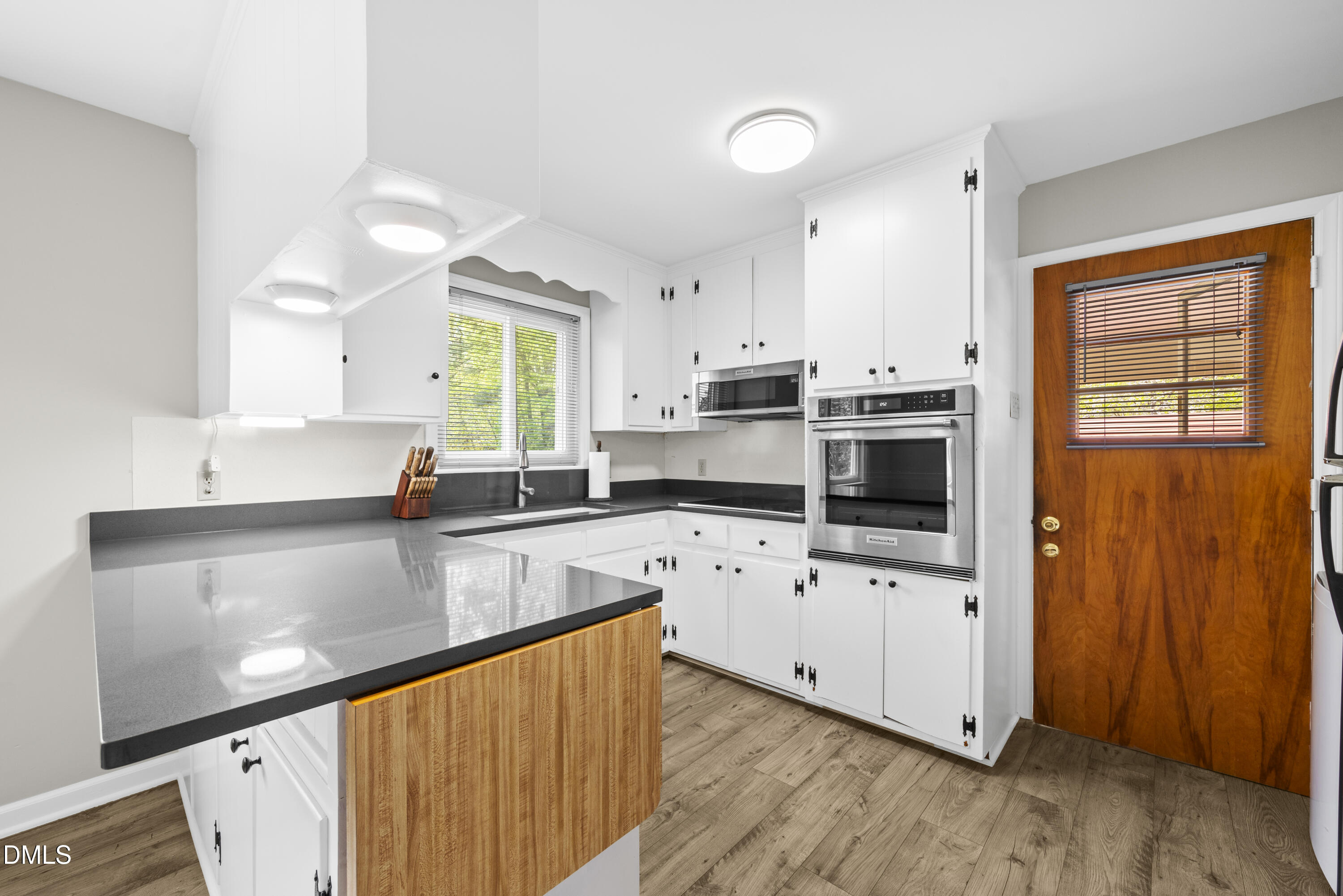 518 Goodwin Road Durham, NC 27712 - Photo 8 of 38 a kitchen with stainless steel appliances white cabinets a sink and a stove