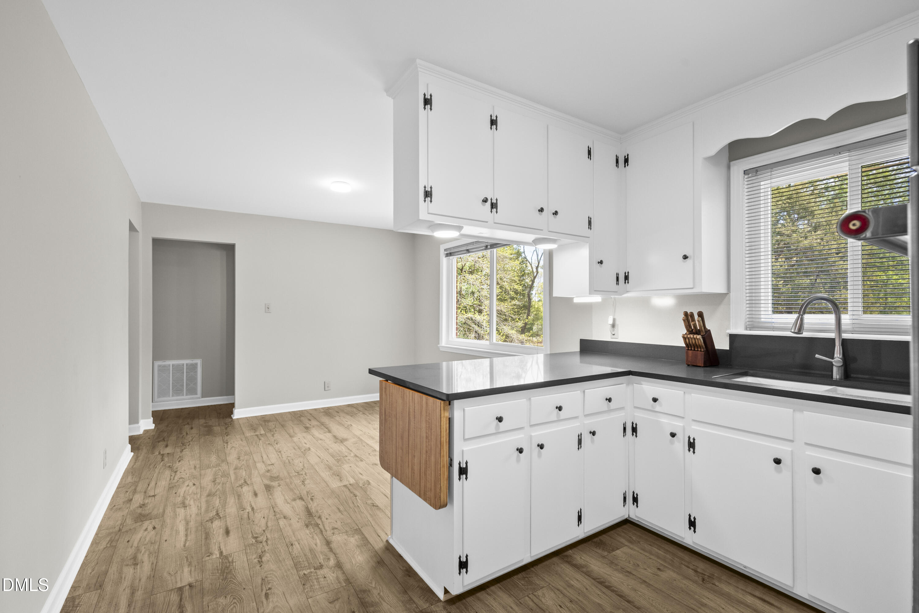 518 Goodwin Road Durham, NC 27712 - Photo 10 of 38 a kitchen with granite countertop a white cabinets and window