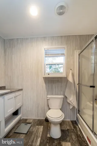 a bathroom with a toilet a sink and a window