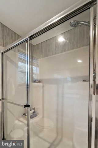 a bathroom with a glass shower door