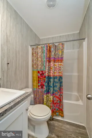 a bathroom with a toilet and a shower