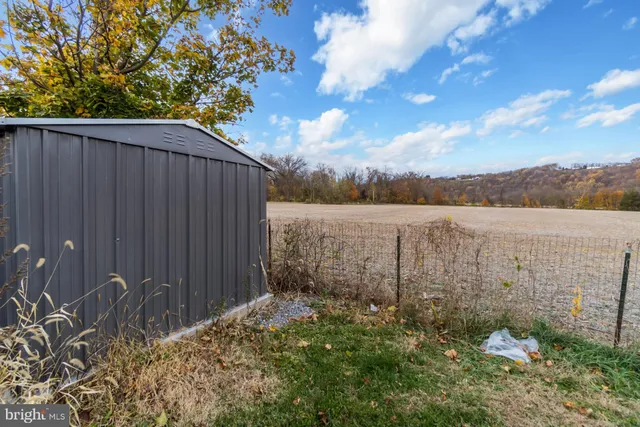 a view of lake with wooden fence