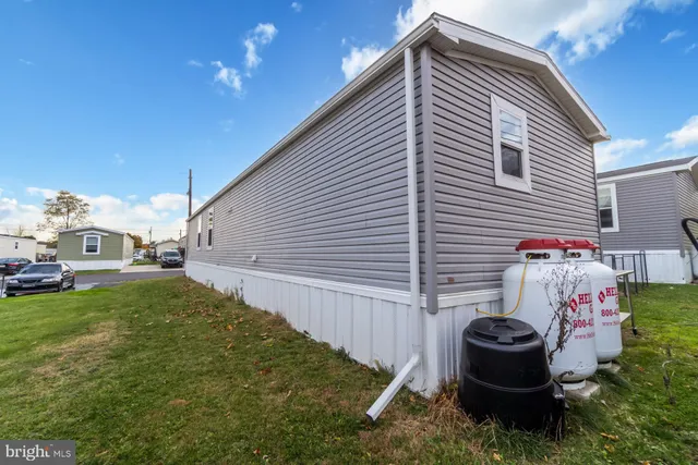 a view of a backyard with plants and outdoor seating