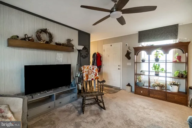 a view of a livingroom with furniture and a flat screen tv