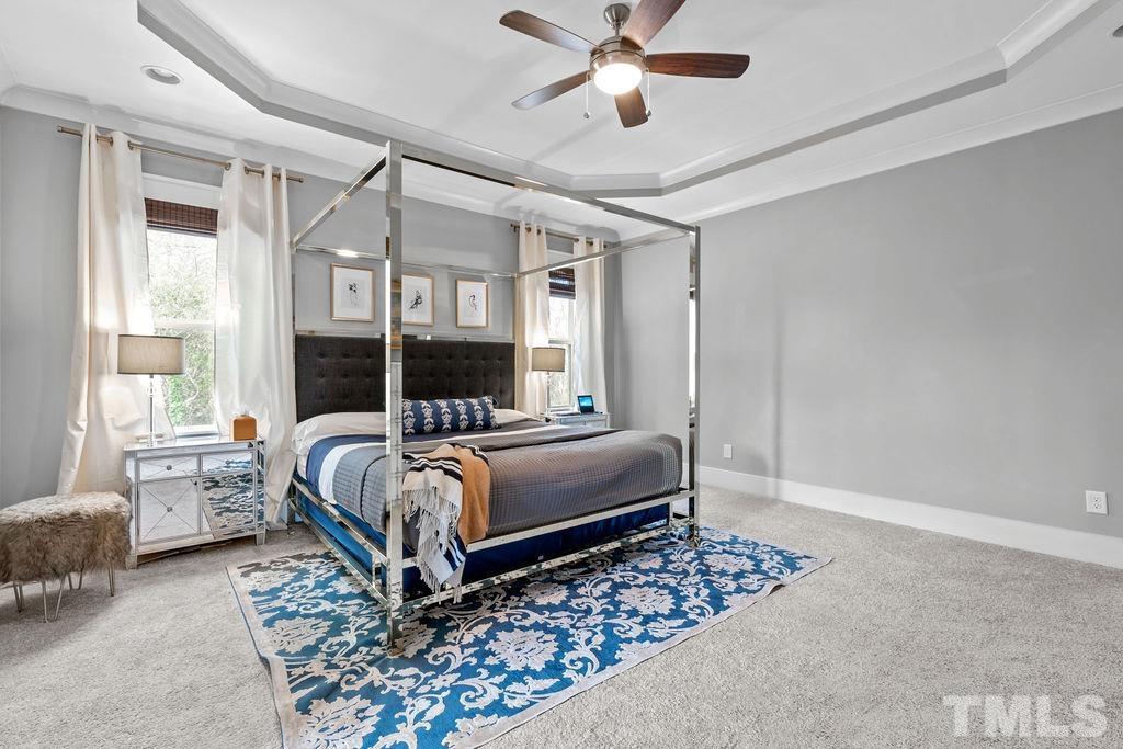 607 Bragg Street Raleigh, NC 27610 - Photo 22 of 44 a bedroom with a bed couch and windows