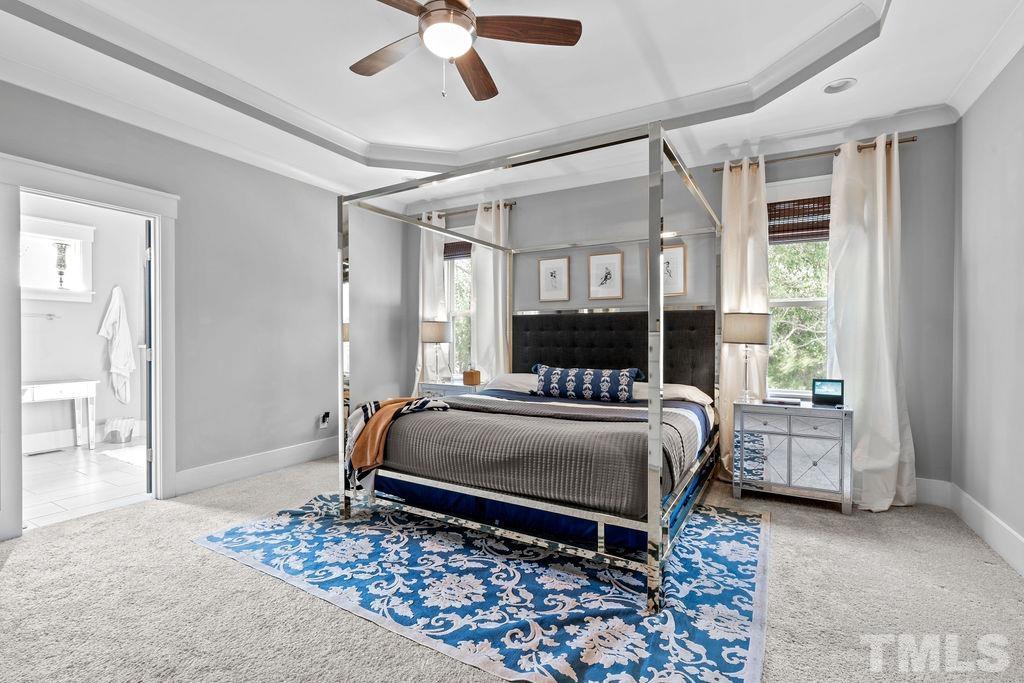 607 Bragg Street Raleigh, NC 27610 - Photo 23 of 44 a bedroom with a bed and a chandelier