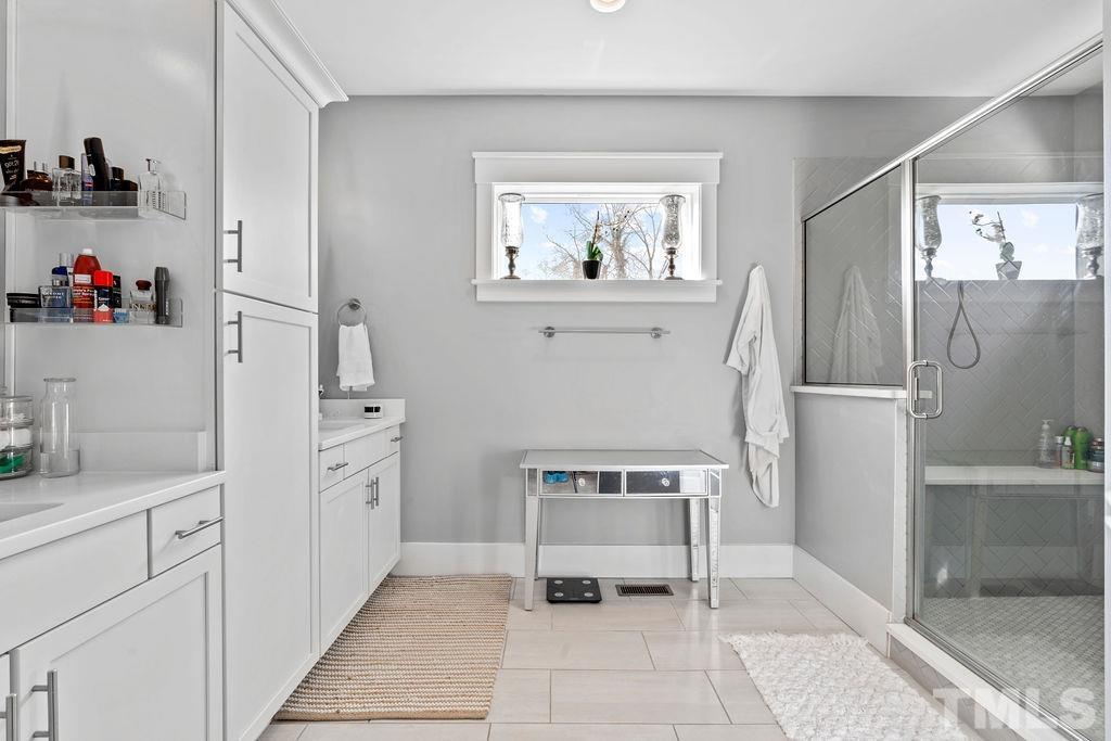 607 Bragg Street Raleigh, NC 27610 - Photo 24 of 44 a bathroom with a sink and a refrigerator