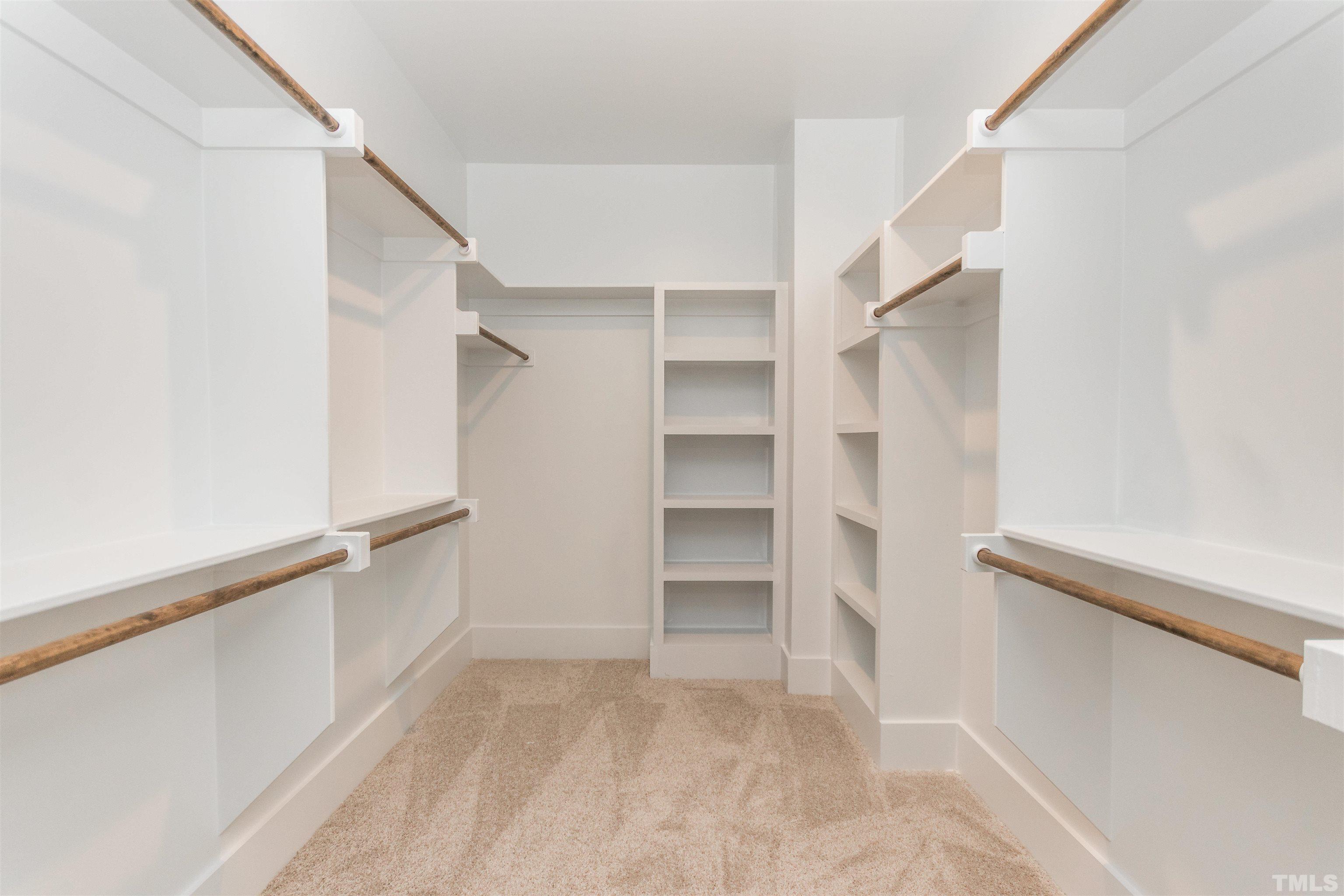 607 Bragg Street Raleigh, NC 27610 - Photo 27 of 44 a view of walk in closet with empty racks