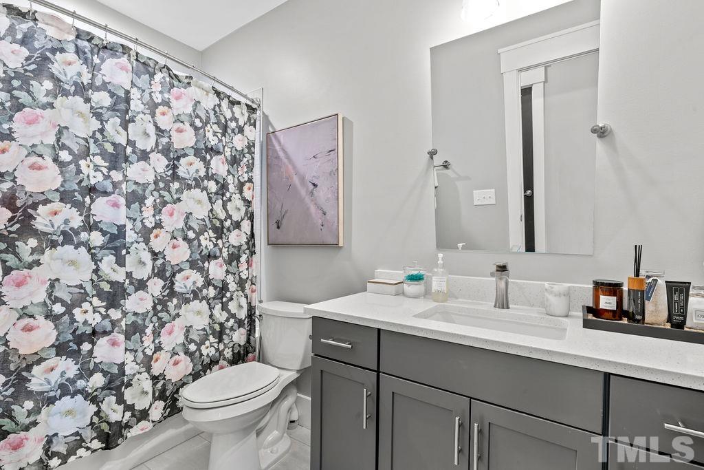 607 Bragg Street Raleigh, NC 27610 - Photo 29 of 44 a bathroom with a sink toilet and mirror
