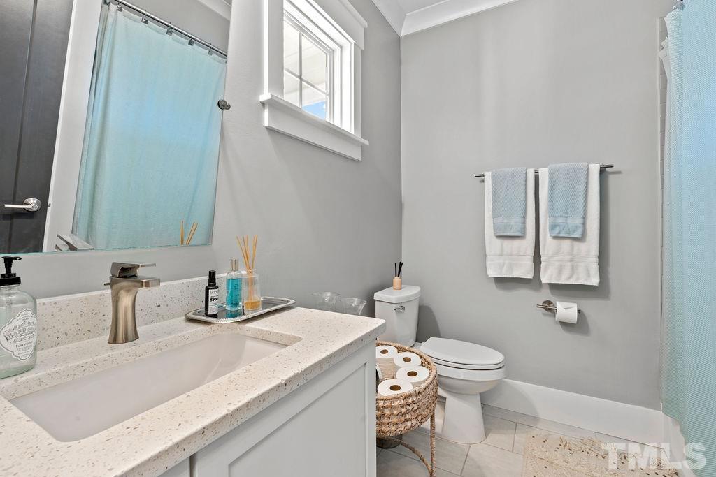 607 Bragg Street Raleigh, NC 27610 - Photo 9 of 44 a bathroom with a granite countertop sink mirror vanity and toilet