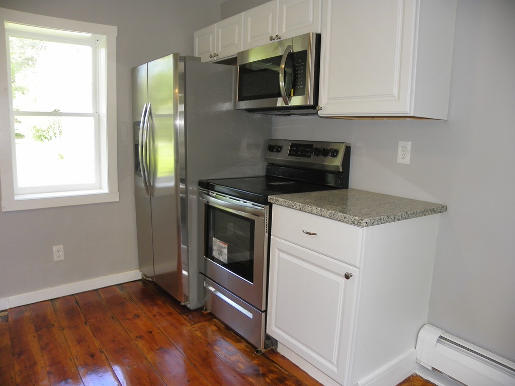 4 Gardner Road Hubbardston, MA 01452 - Photo 7 of 22 a kitchen with a stove microwave and sink