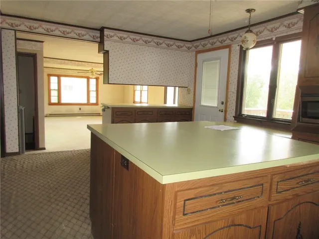 a view of a kitchen with a large window