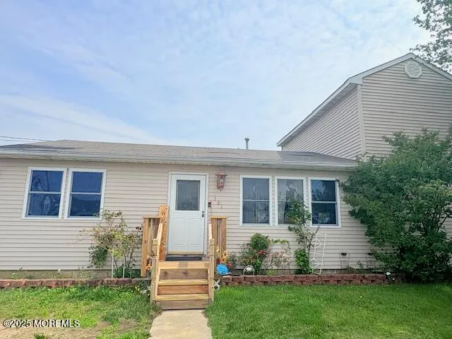 a front view of a house with a garden and yard