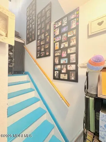 a view of a room with windows and furniture