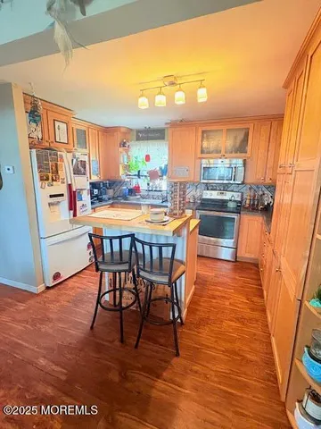 a dining room with furniture a rug and wooden floor