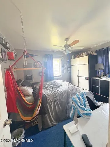 a bedroom with bed and a window