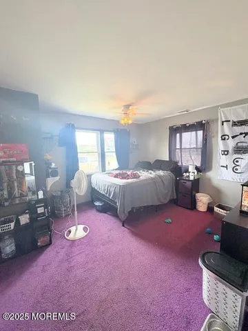 a bedroom with bed and window