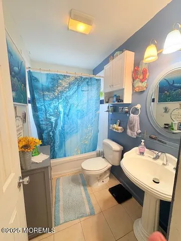 a bathroom with a sink mirror vanity and toilet