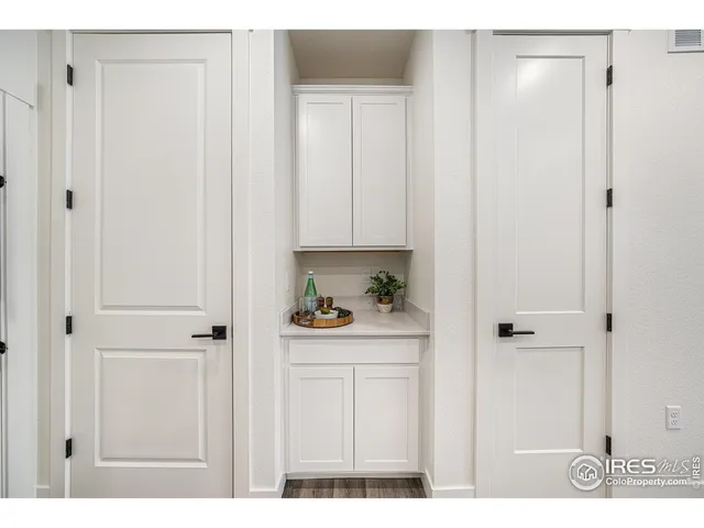 a kitchen with white cabinets and white appliances