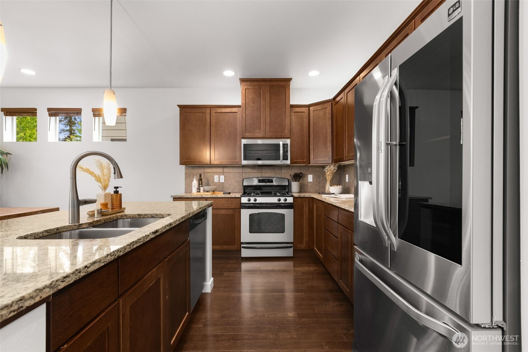 16516 2nd Park Southeast Bothell, WA 98012 - Photo 14 of 39 a kitchen with stainless steel appliances granite countertop a refrigerator a stove and a sink