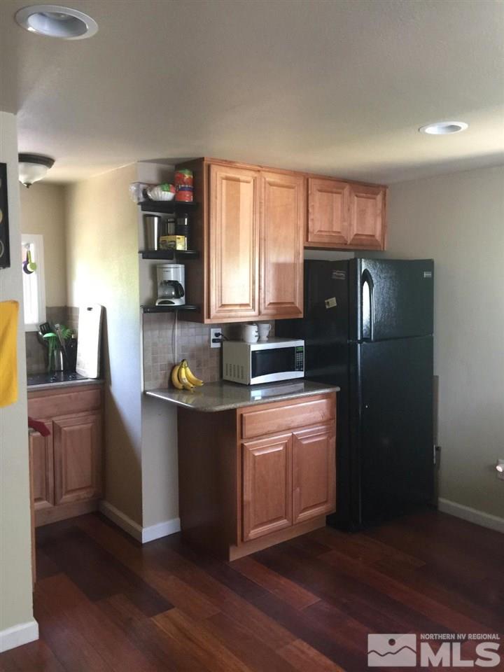 1333 Terrace Drive Reno, NV 89503 - Photo 12 of 21 a kitchen with granite countertop a refrigerator and a stove top oven