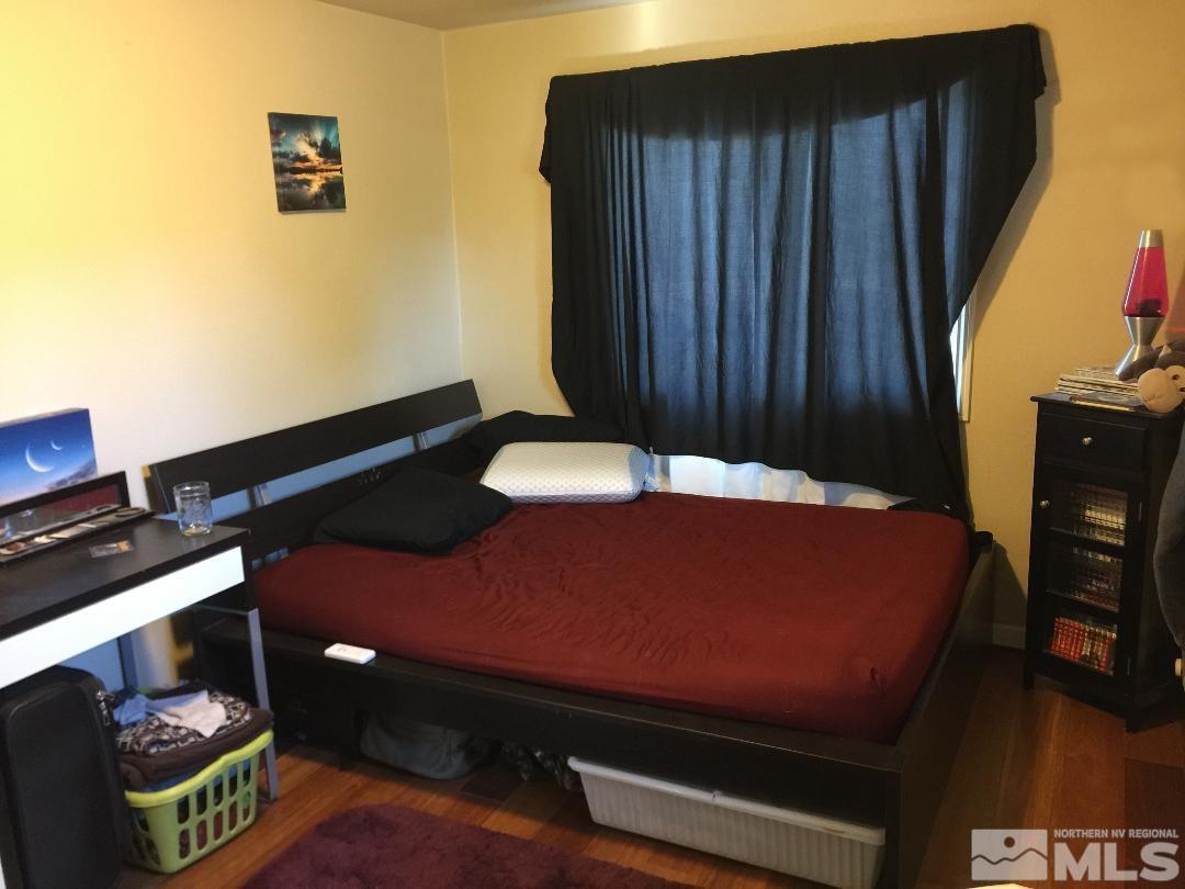 1333 Terrace Drive Reno, NV 89503 - Photo 14 of 21 a bed sitting in a bedroom next to a window with kitchen
